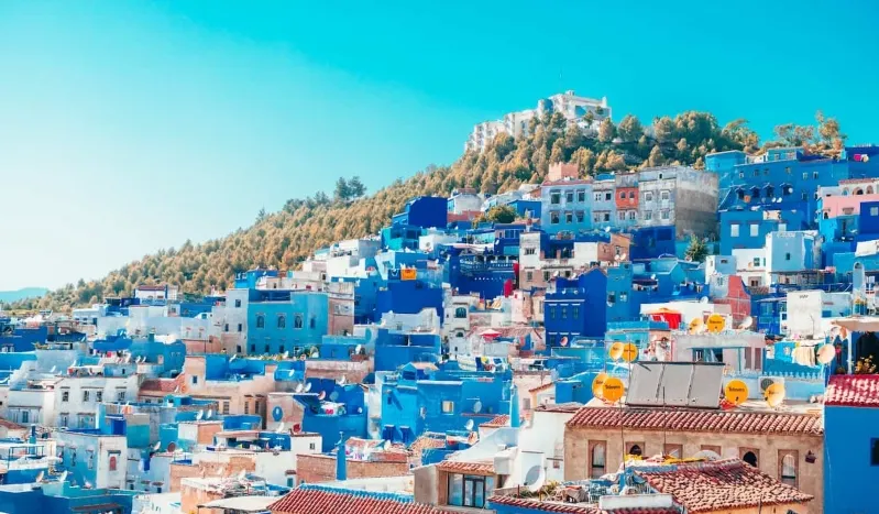 A scenic view of Chefchaouen, Morocco, showcasing its iconic blue buildings and vibrant streets, emphasizing safety in morocco for visitors. 