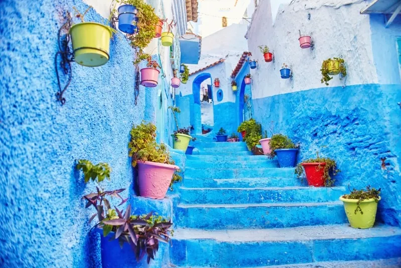 Blue-painted walls of Chefchaouen, Morocco, showcasing the town's vibrant charm and unique architectural beauty. 