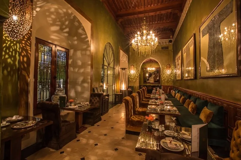 A cozy hotel dining room adorned in green, perfect for budget travelers exploring Morocco.