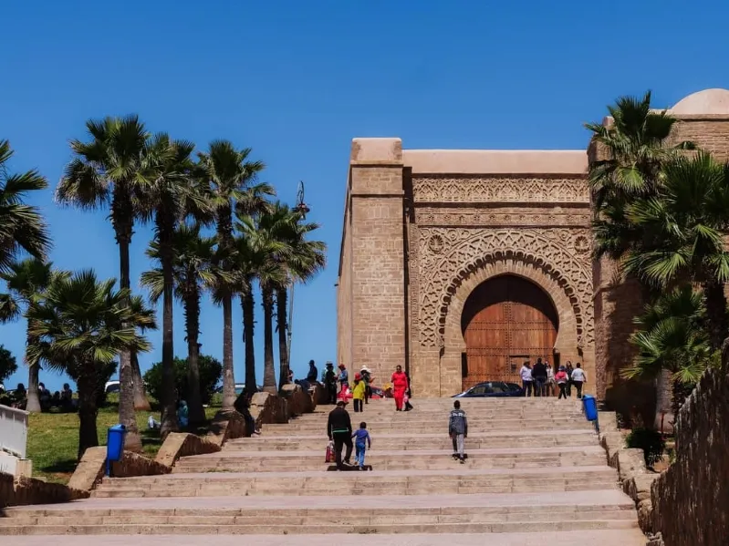 The entrance to a mosque in Morocco, showcasing intricate architecture and vibrant colors, inviting visitors to Rabat.
