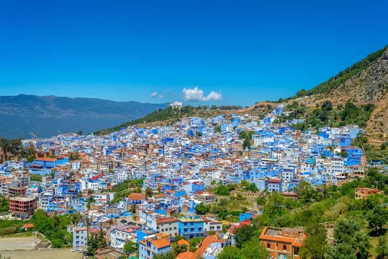An enchanting glimpse of Chefchaouen, Morocco, featuring its famous blue architecture, perfect for those planning a visit Rabat.