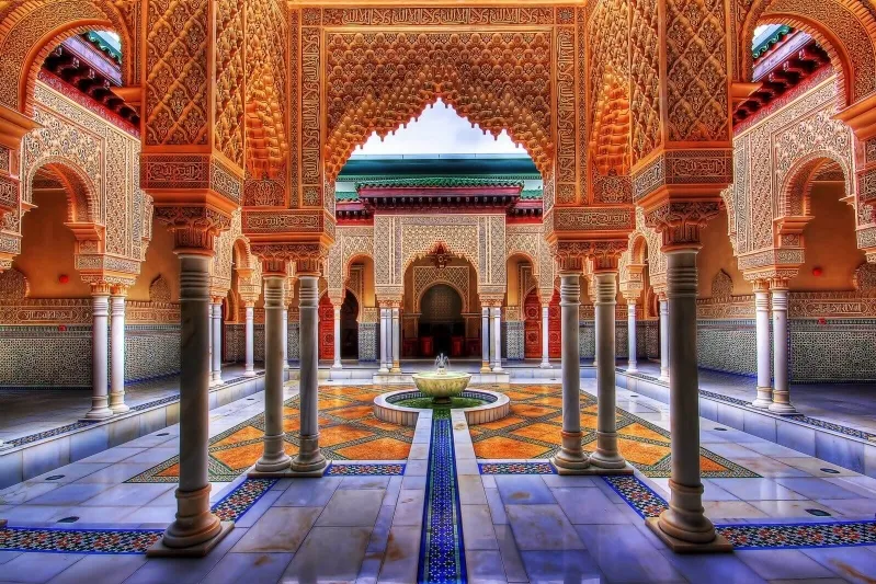 The royal palace courtyard in Morocco, featuring stunning design elements and lush surroundings, perfect for travel inspiration.
