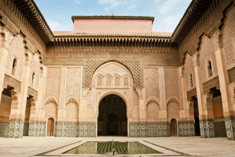 The courtyard of the royal palace in Marrakesh, Morocco, showcasing intricate architecture and vibrant cultural elements.