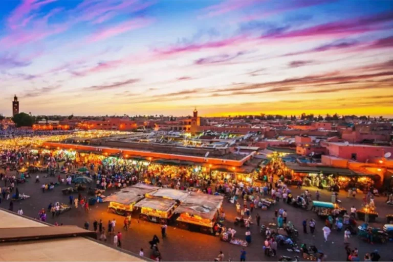 A stunning sunset over Marrakesh, showcasing the city's vibrant colors, perfect for budget travelers in Morocco.