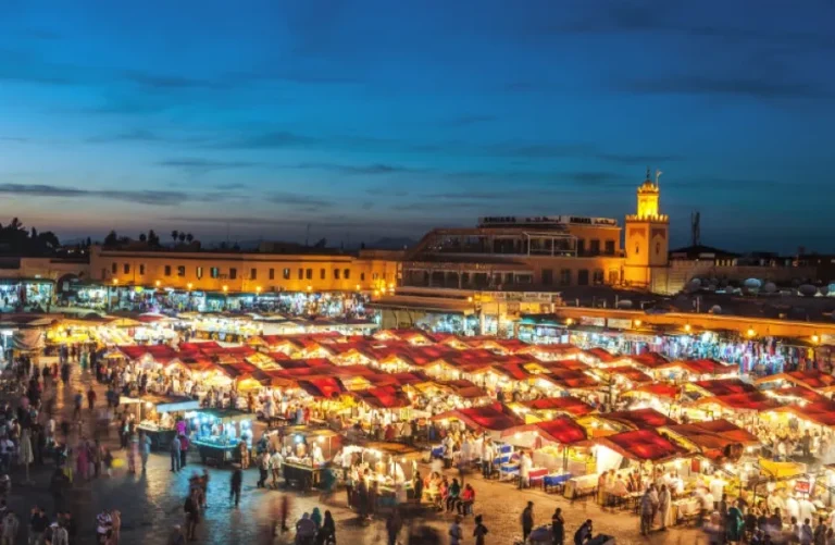 A vibrant view of Marrakesh at night, showcasing its illuminated streets and lively atmosphere, reflecting Morocco's safety.