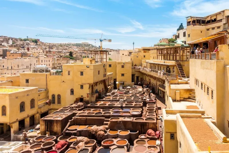 A bustling Moroccan cityscape filled with people and buildings, showcasing the vibrant life and culture of Morocco.