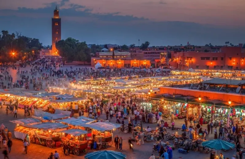 A stunning view of Marrakech at dusk, showcasing the vibrant cityscape and rich cultural heritage, perfect for travel enthusiasts.