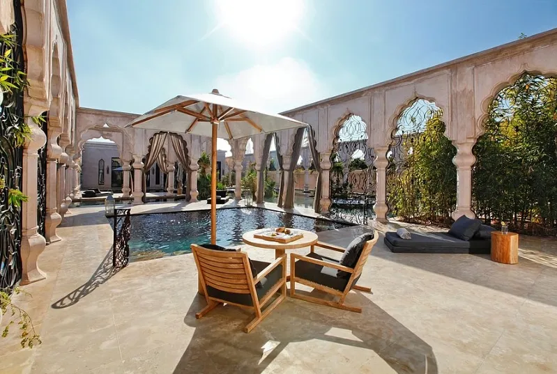 Riad Al-Sakhr's elegant pool area, surrounded by lush gardens, exemplifying the charm of resorts in morocco.