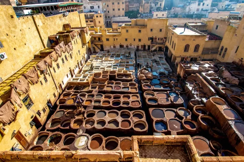 The bustling cityscape of Marrakech, Morocco, featuring traditional architecture and elements related to Fes desert tours.