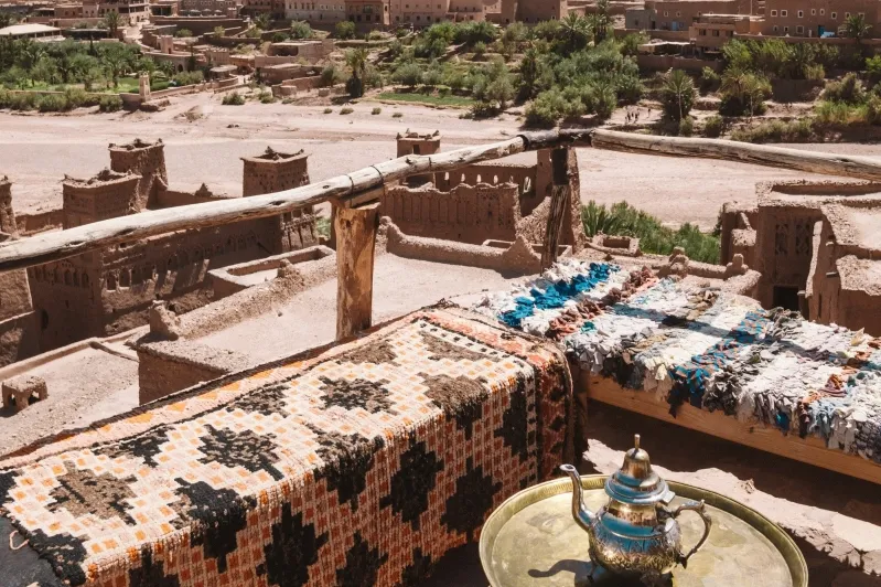 A panoramic view of Morocco's cityscape from a terrace, showcasing vibrant architecture and bustling streets.