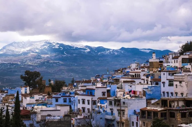  The picturesque blue city of Chefchaouen in Morocco, a must-visit destination for tours from Australia, featuring charming architecture.