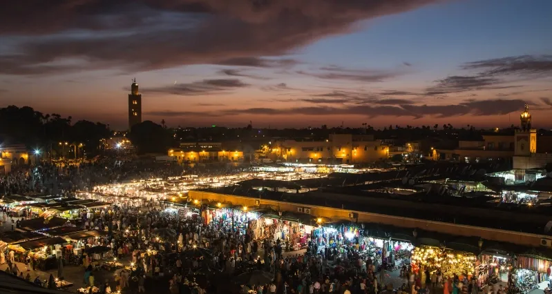 A stunning view of Marrakesh at dusk, showcasing its vibrant colors and architecture, perfect for Morocco travel packages.