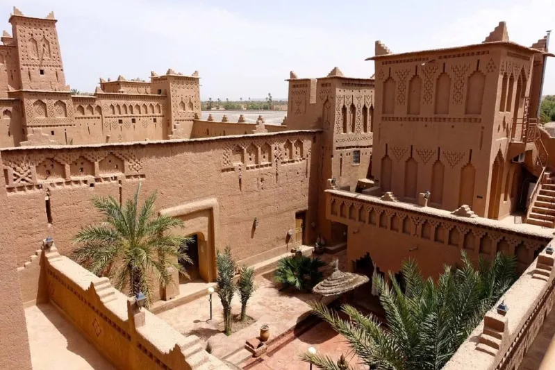 A serene courtyard of an ancient building set against the arid backdrop of the Moroccan desert, ideal for Australian travelers. 