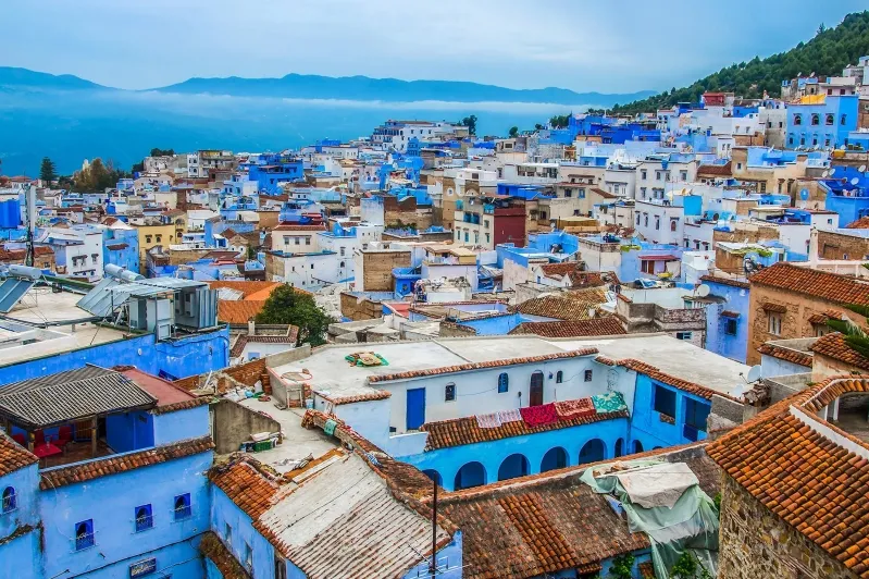 A scenic view of Chefchaouen, Morocco, showcasing its iconic blue buildings and vibrant streets, perfect for Morocco tours. 