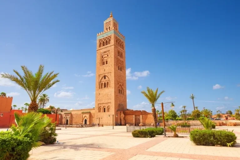 A majestic clock tower stands prominently in a bustling plaza, a highlight of Morocco tours from the USA.