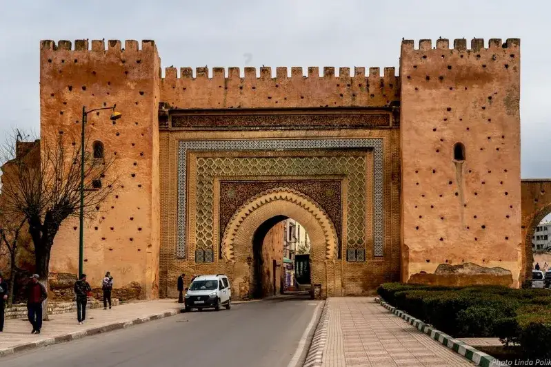 The entrance to Marrakech, showcasing vibrant architecture and bustling activity, part of Imperial Cities Tours Morocco.