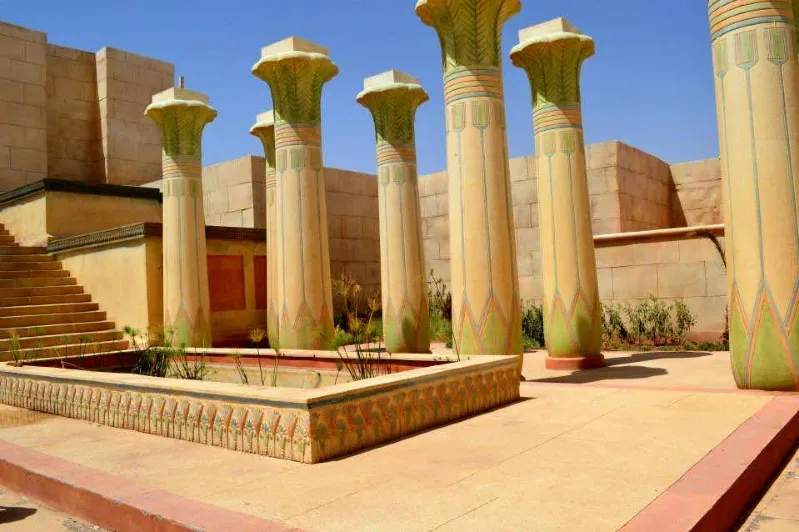 Stone columns with green paint, located in Ouarzazate, Morocco, known for its Hollywood film industry connections. 