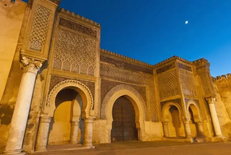 The grand entrance to the Sultan's palace in Morocco, showcasing intricate architecture during a day trip from Marrakech to Ouarzazate.