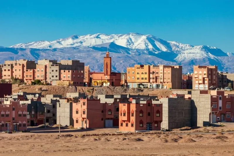 A scenic view of Morocco's city with snow-capped mountains in the background, highlighting the The Trip to Ouarzazate.