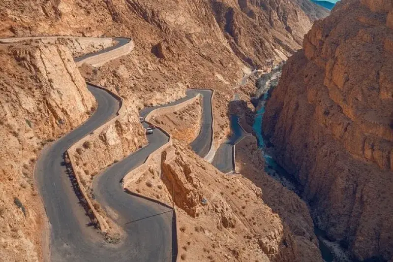 A scenic winding road through the mountains, showcasing the beauty of the landscape during a trip to Ouarzazate. 