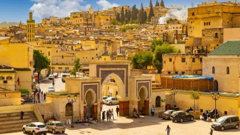 A scenic view of Marrakech, Morocco, showcasing its vibrant architecture and bustling streets, with a Travel from Marrakech to Ouarzazate. 