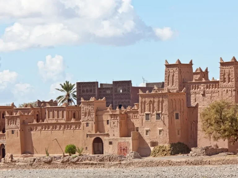 A large brown building with numerous windows, showcasing the architectural beauty of Ouarzazate's attractions.
