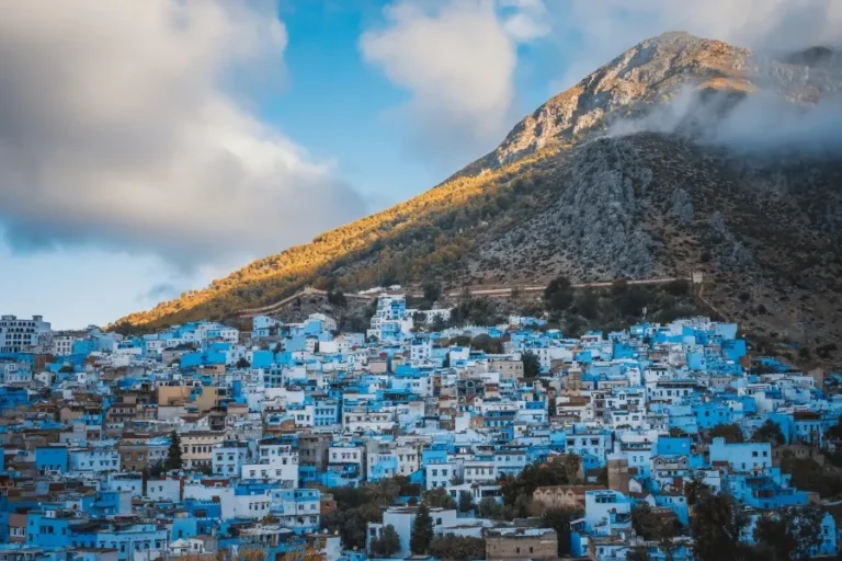 Scenic view of Chefchaouen, Morocco, showcasing its iconic blue buildings and mountainous backdrop, a top travel destination.