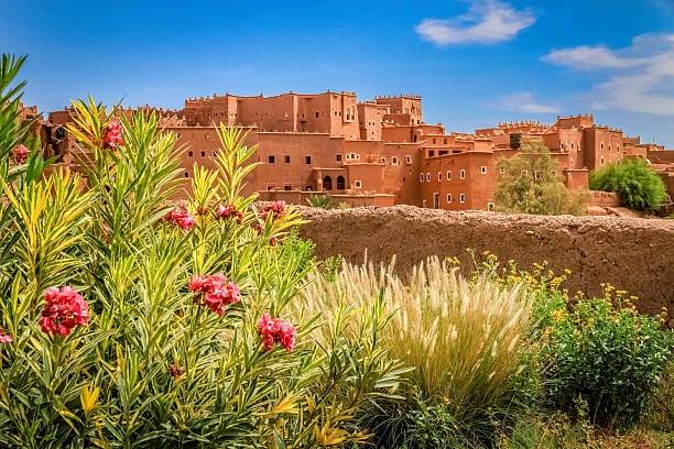 Best time to travel to Morocco showing desert dunes, Marrakech city, Atlas Mountains, and coastal weather seasons
