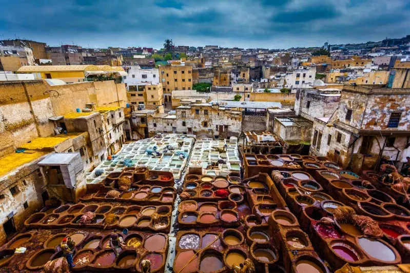 A vibrant market scene in Morocco showcasing an array of colorful pots and pans, highlighting local craftsmanship and culture. 