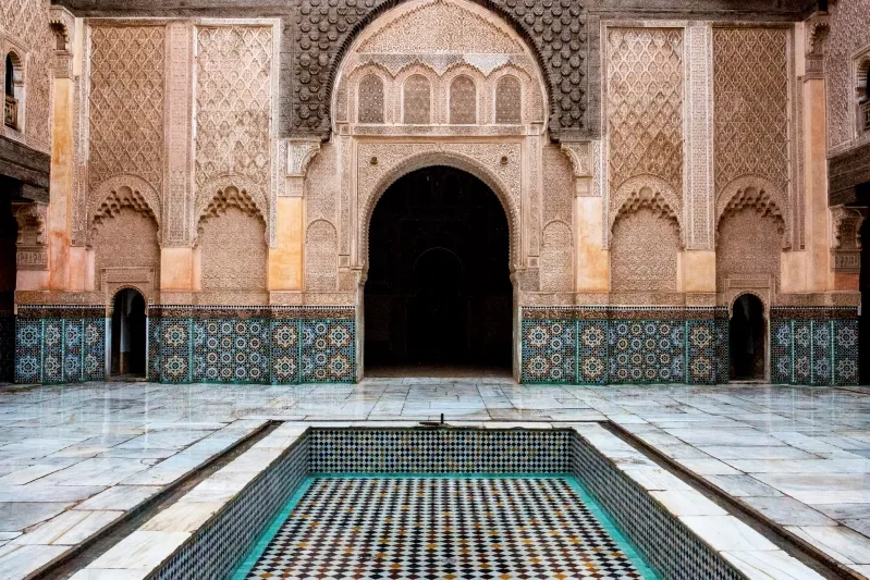 Courtyard of the Sultan's palace in Marrakesh, showcasing intricate architecture and vibrant Moroccan design elements.
