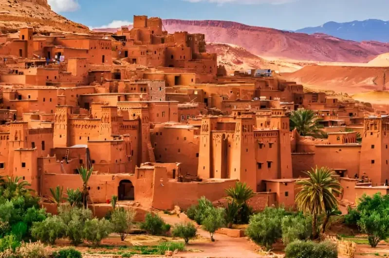 The vibrant city of Sahara in Morocco, featuring traditional buildings against a backdrop of the vast desert. 