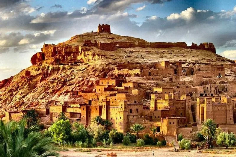Scenic hillside view of a Moroccan city, showcasing its vibrant buildings and surroundings, ideal for tour packages.