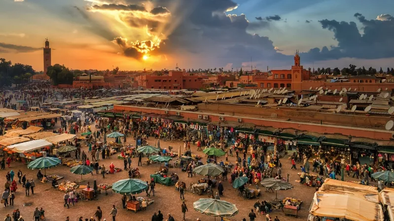 Sunset over Marrakech, Morocco, with vibrant colors illuminating the city skyline, popular among tour groups.