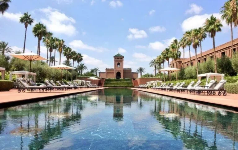 A luxurious Marrakech hotel showcasing traditional Moroccan architecture, inviting guests for an all-inclusive vacation experience.