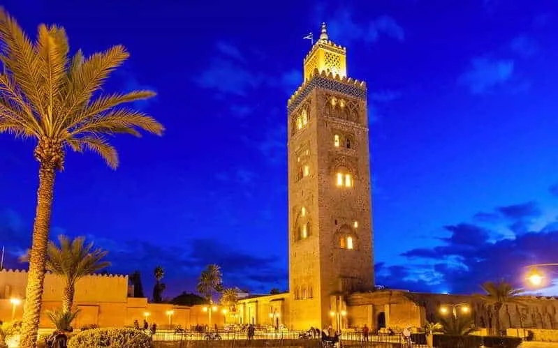 Clock tower of the mosque in Marrakech, Morocco, showcasing intricate architecture and cultural significance.Morocco specialist tour operators