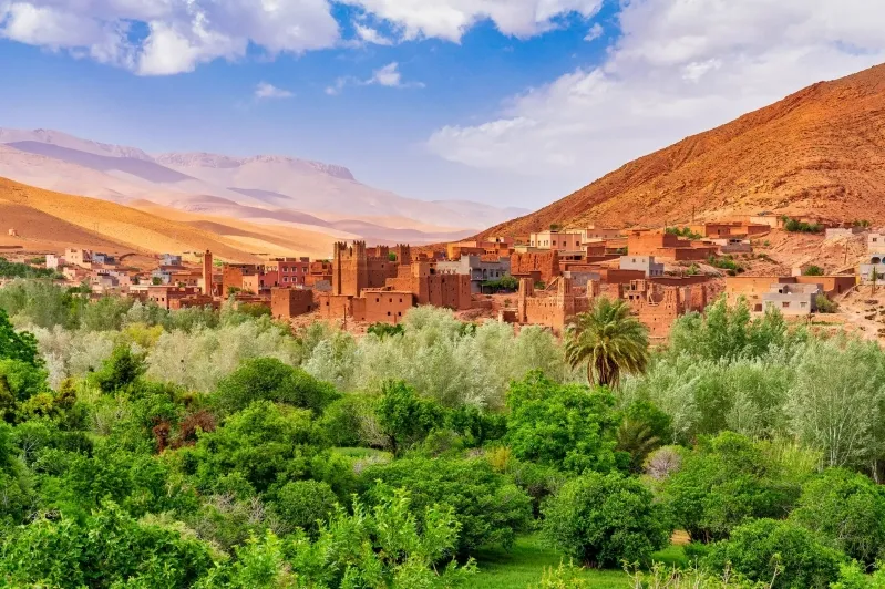 A scenic view of the village of Atlas nestled in the Atlas Mountains of Morocco, showcasing its traditional architecture and landscape. 