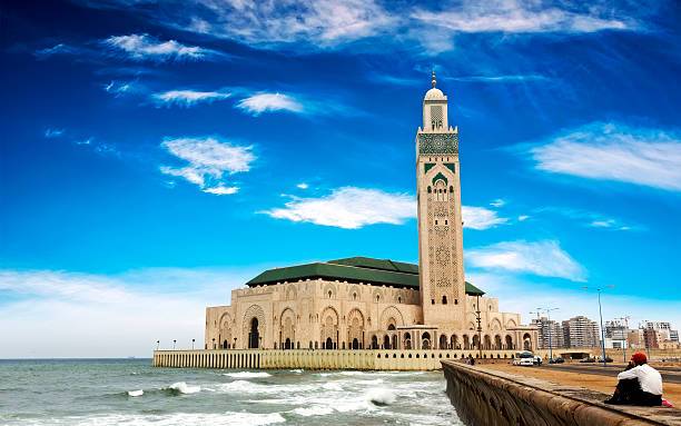 Tourists visiting Casablanca Morocco featuring Hassan II Mosque, Atlantic coastline, modern city skyline, and cultural guided tours