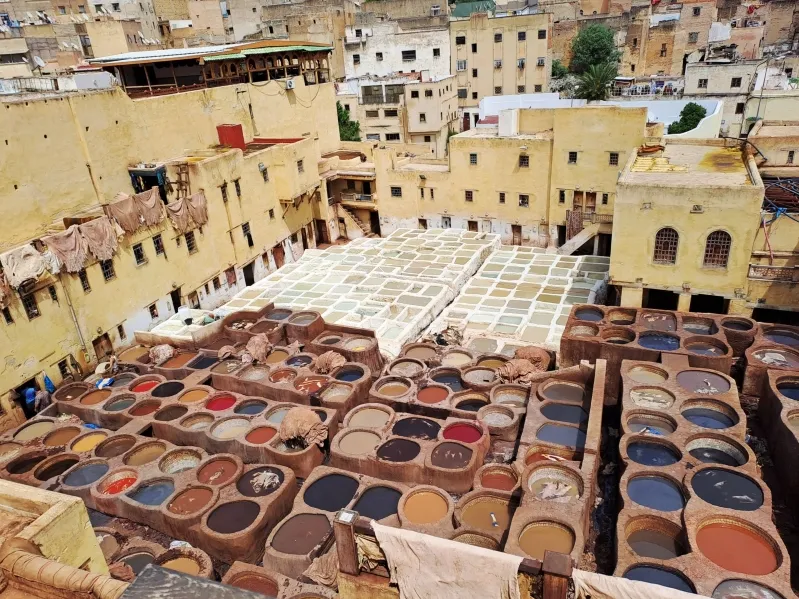 Vibrant display of colorful pots in a Moroccan city, showcasing traditional Amazigh craftsmanship and culture.