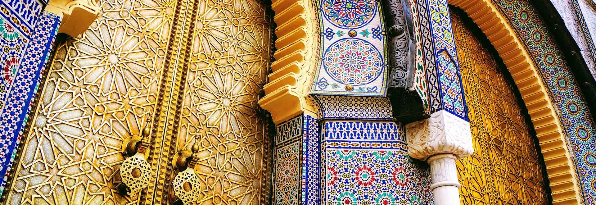 Travelers on a 2-day Morocco desert tour from Ouarzazate to Fes with camel trekking in Merzouga and scenic desert landscapes