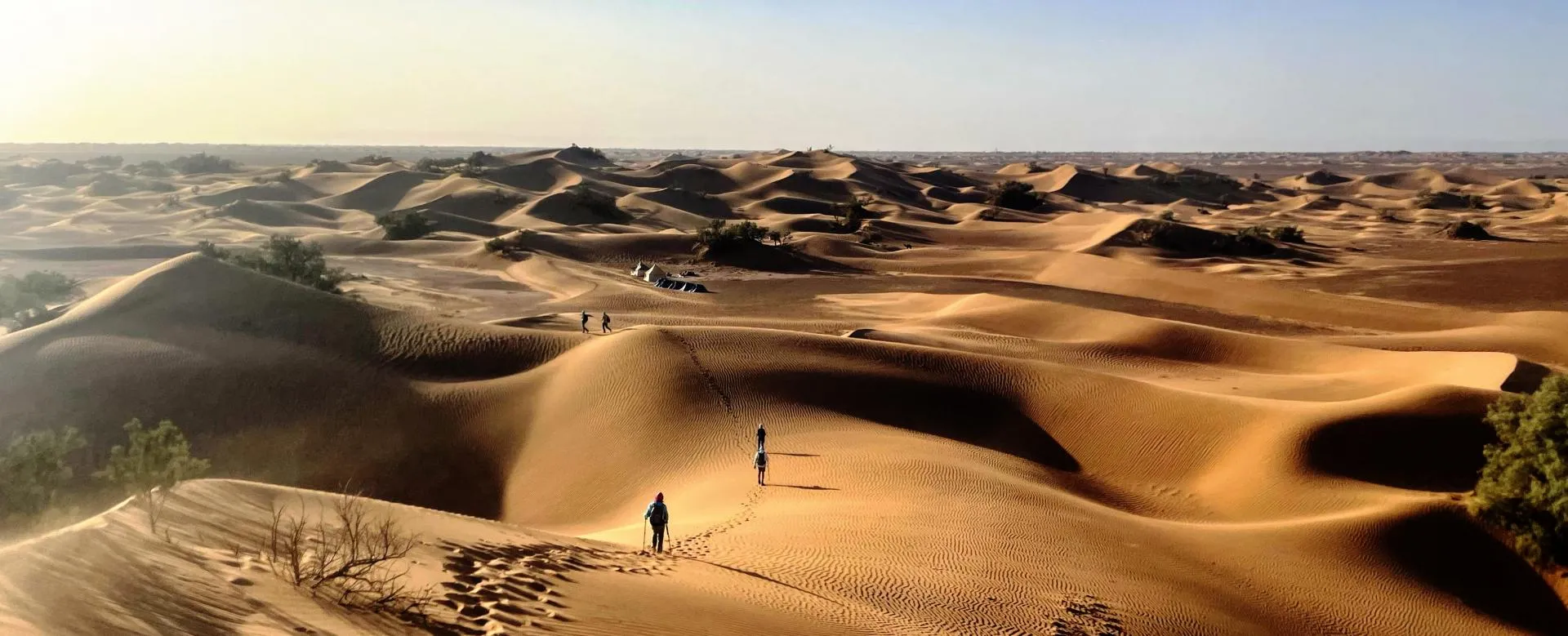 Morocco Sahara Desert featuring Erg Chebbi dunes, camel trekking, luxury desert camps, sunset views, and desert landscapes near Merzouga