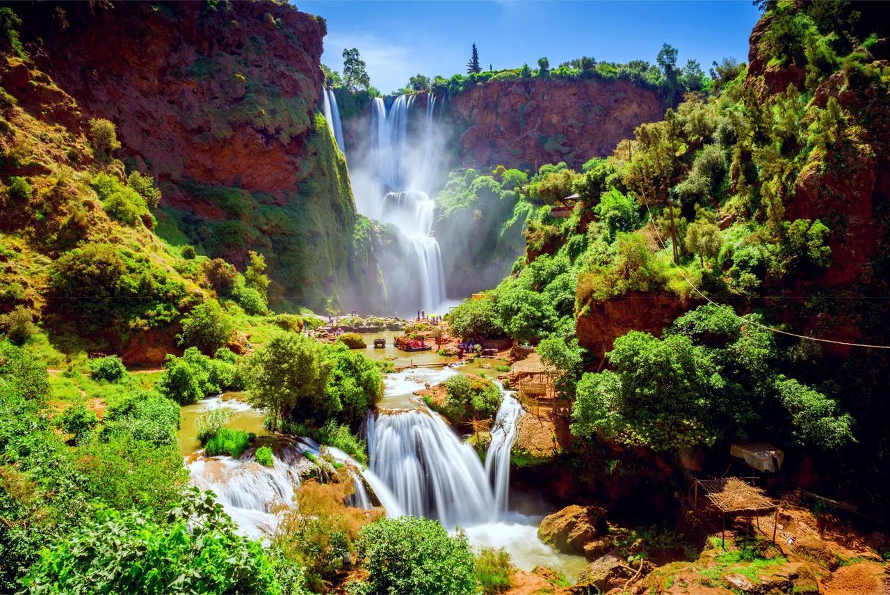 Ouzoud Waterfalls in Morocco with cascading waterfalls, green cliffs, and natural pools surrounded by Atlas Mountains scenery
