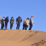 Students experiencing Sahara Desert educational tour in Morocco with camel trekking, desert camps, and cultural learning activities